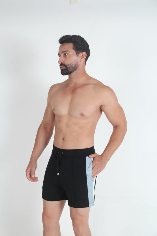 Black fleece shorts with grey side panels and a drawstring waist, viewed from the side.