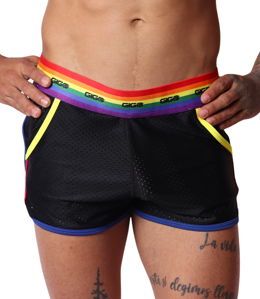 Front view of black mesh Gigo Pride shorts with rainbow waistband, yellow trim, and blue hem.
