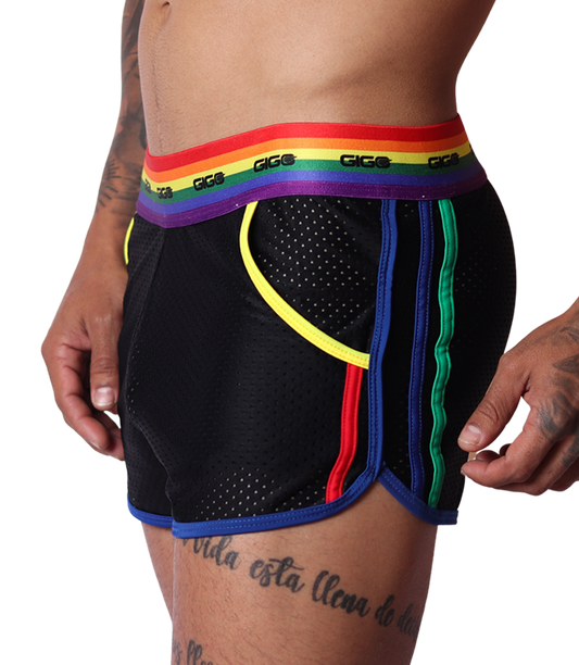 Side view of Gigo Pride mesh shorts in black with rainbow striped waistband and colorful trim on a male model.