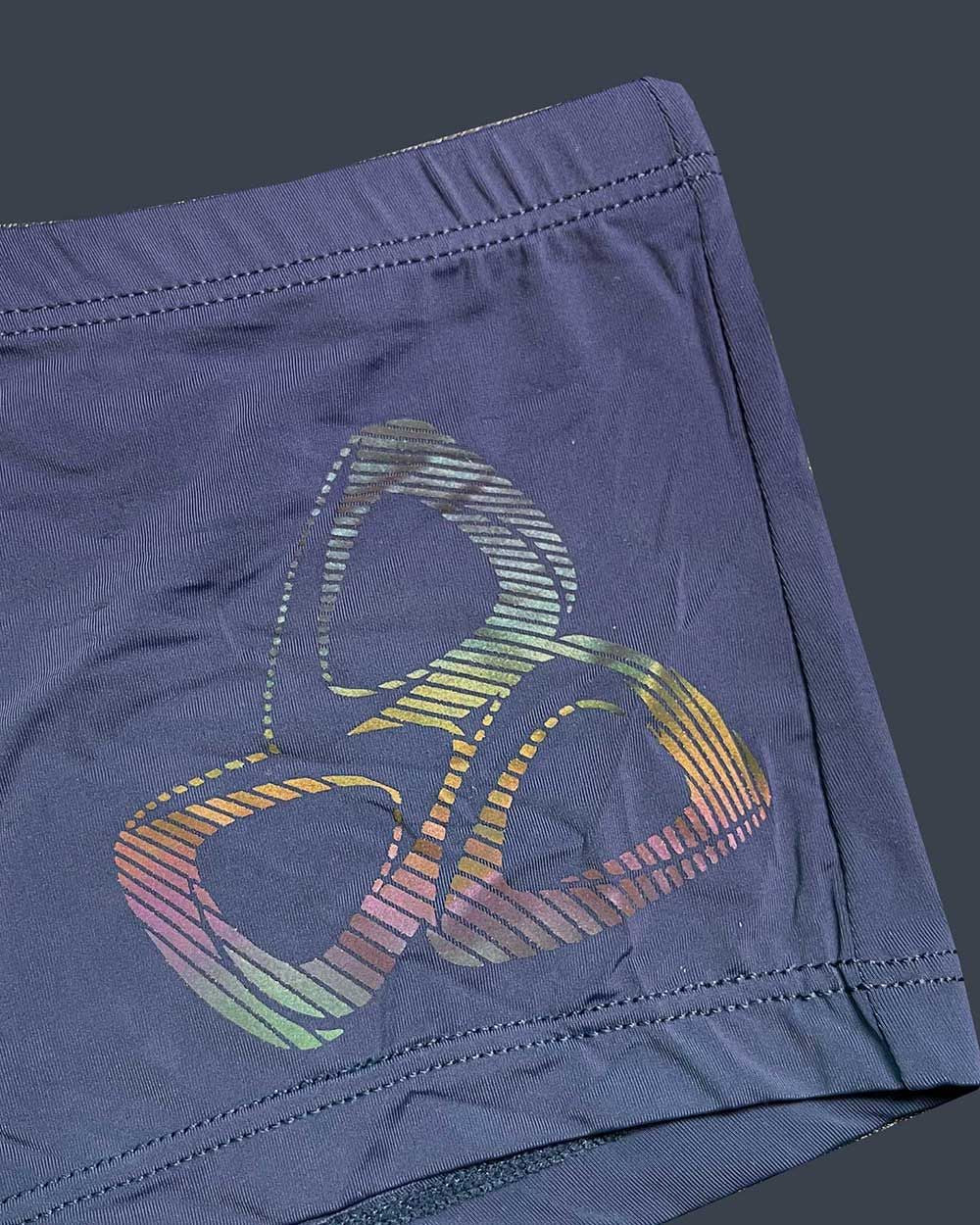 Dark blue silk athletic shorts with vibrant rainbow-striped abstract logo by private structure bruth4390 bare hipster