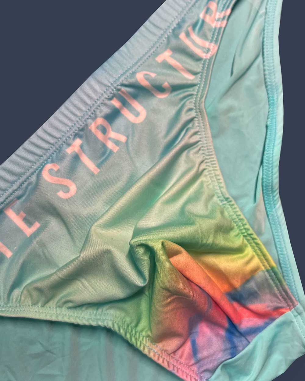 Pastel green tie-dye cyan mist bikini bottom from private structure with pink instructor print on the waistband
