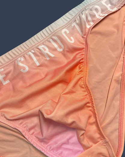 Peach and pink gradient fabric bikini bottom with structure printed on the waistband from private structure bare collection