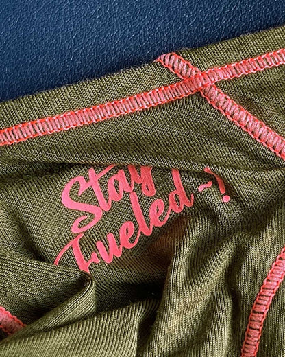 Olive green ribbed fabric prime eutopia bikini brief with pink embroidered text and matching pink stitching