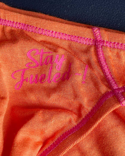 Orange athletic underwear with pink embroidered text and matching stitching private structure prime eutopia bikini brief