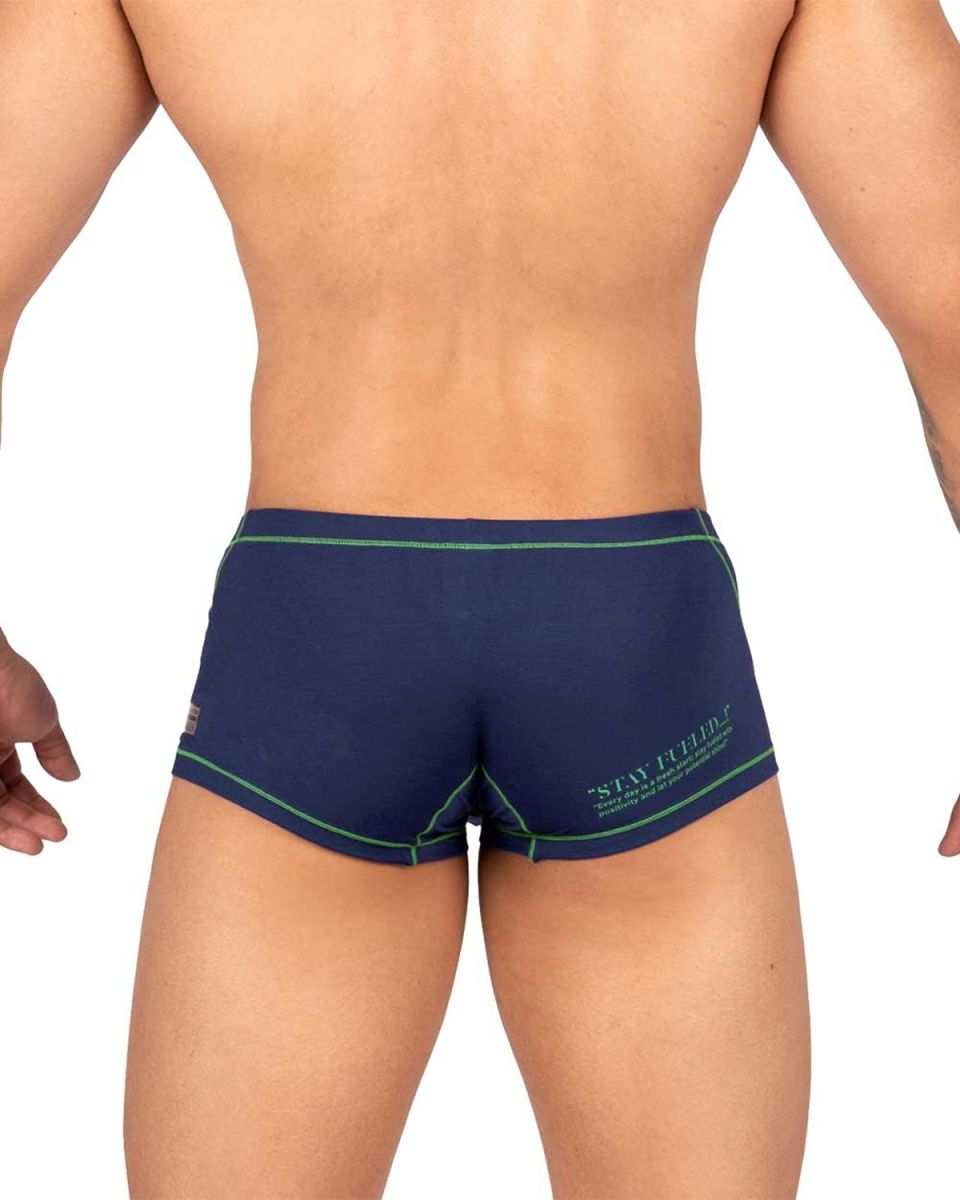 Back view of private structure navy blue swim trunks with green trim and stay firm logo for active beachwear