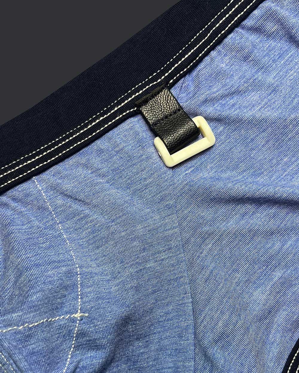 Private structure lcut4359 barn boy low rise trunk in denim with black leather strap and cream plastic buckle on blue fabric