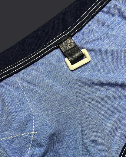 Private structure lcut4359 barn boy low rise trunk in denim with black leather strap and cream plastic buckle on blue fabric