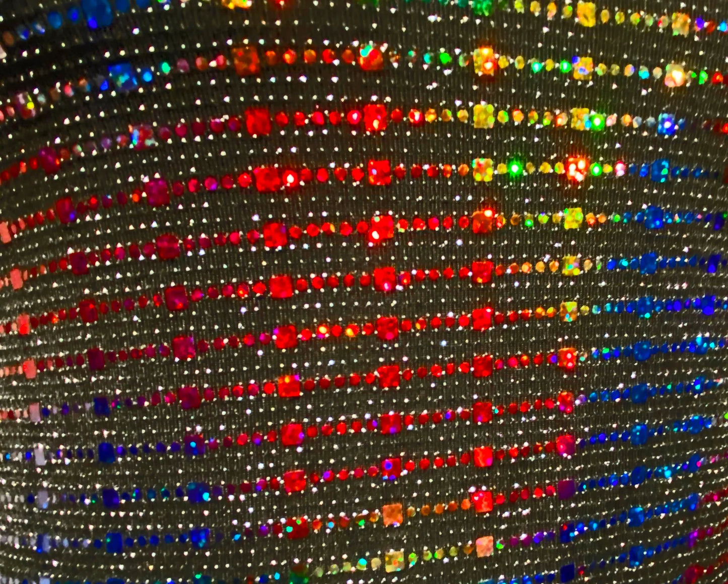 Rainbow sequin tank featuring shimmering black fabric with vibrant rainbow rhinestones in diagonal rows