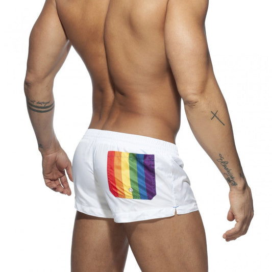 Back side of white rainbow swim short with vibrant rainbow flag patch on swim trunks back pocket