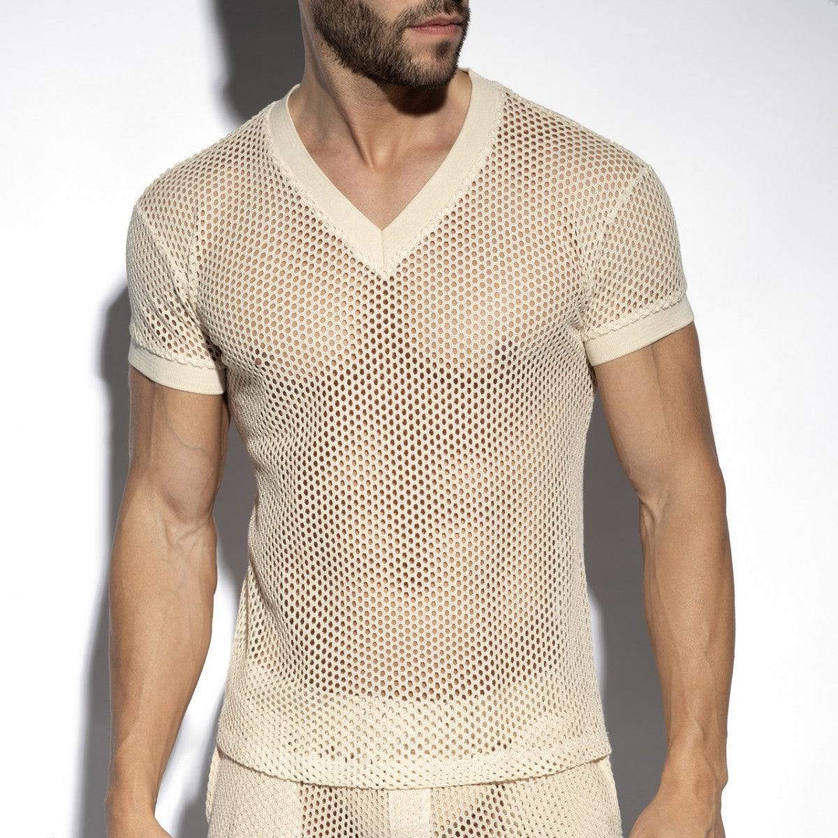 Beige raw crochet t shirt with v neck, short sleeves, mesh fabric, and solid trim detailing