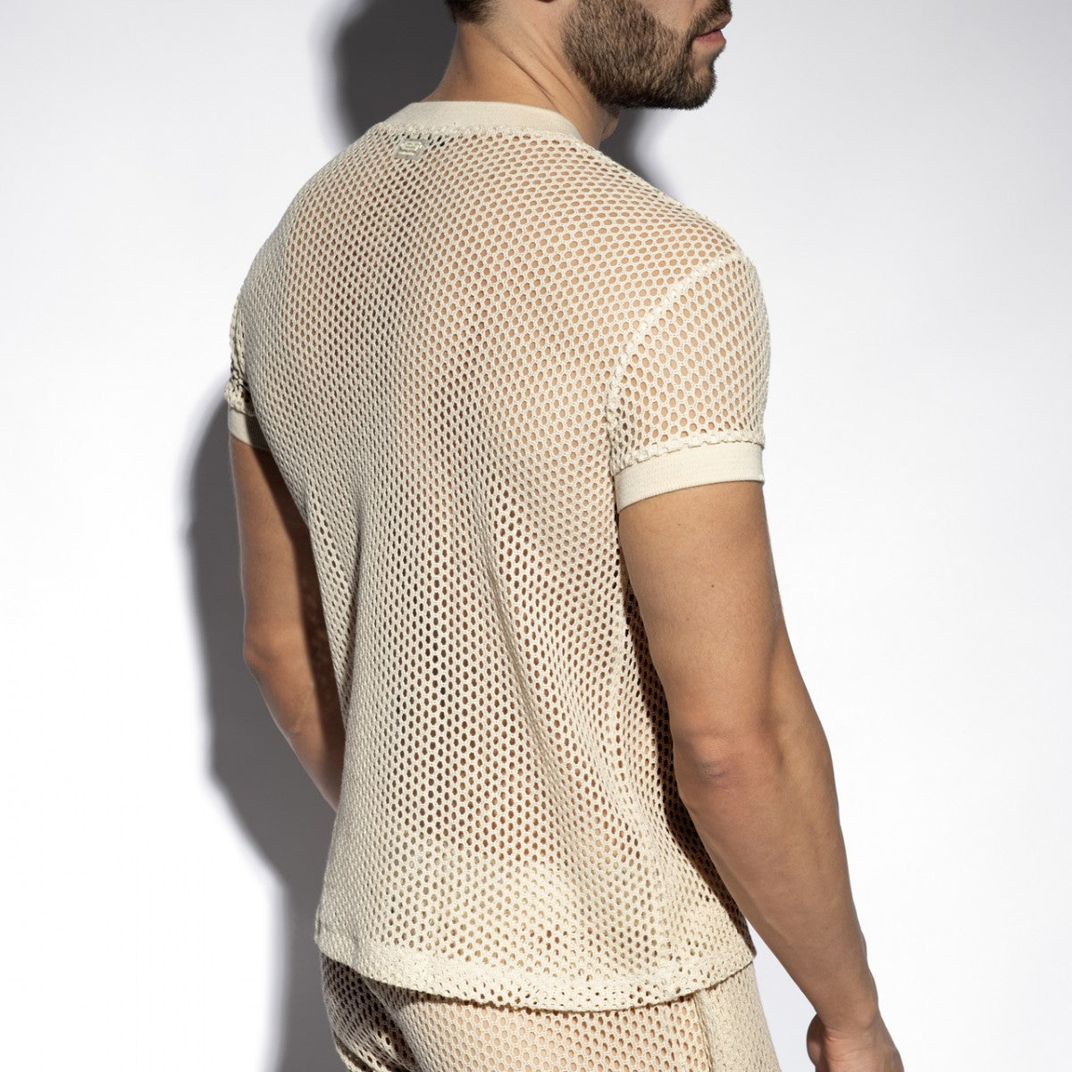 Beige raw crochet t-shirt with mesh fabric, short sleeves, round neckline, and solid ribbed cuffs