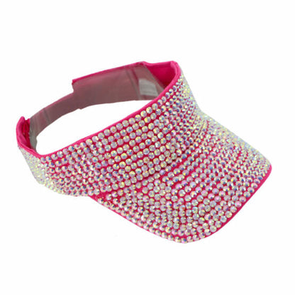 A vibrant pink rhinestone visor with a dense sparkling array of clear and iridescent rhinestones in five colors