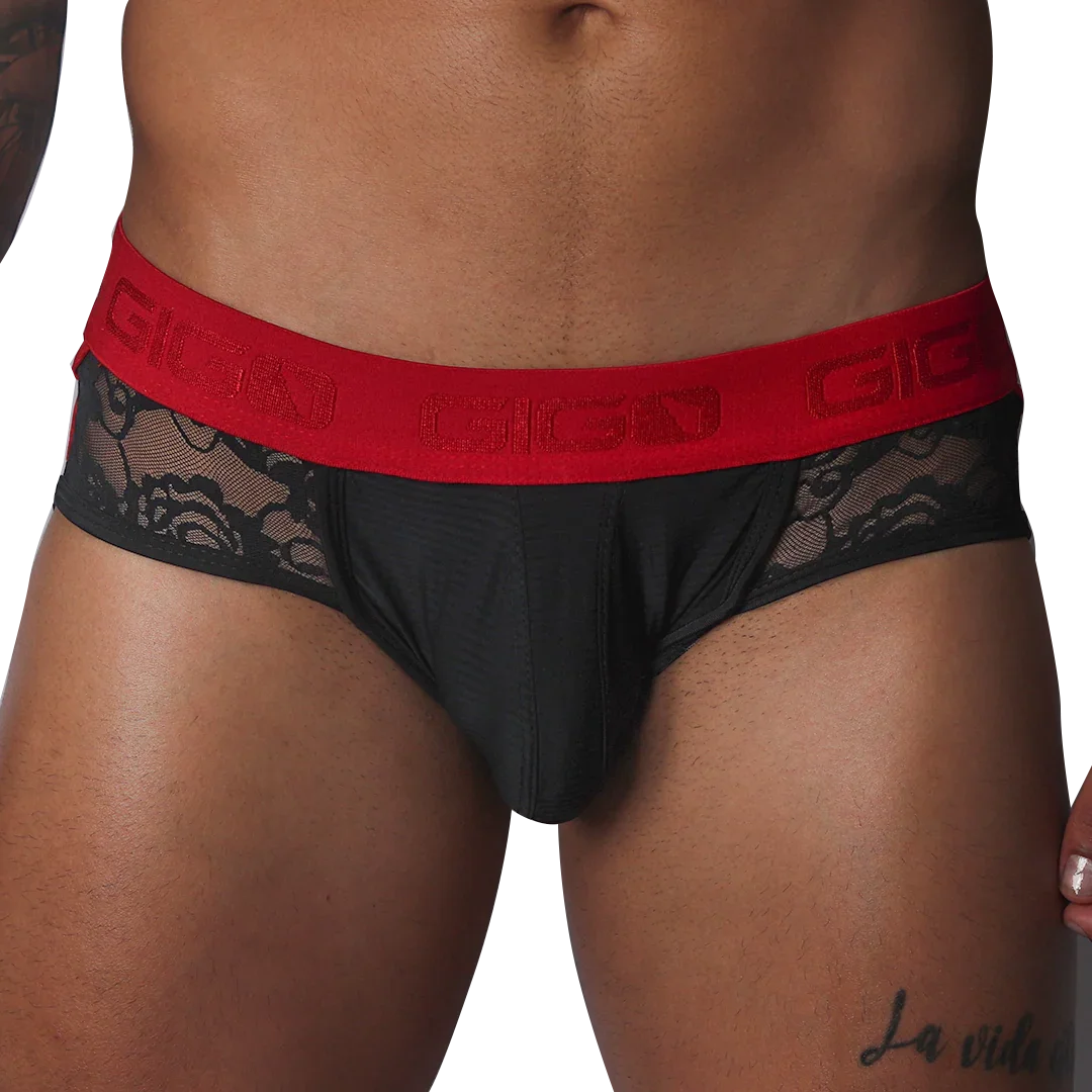 Black jock thong with floral lace side panels and a wide red elastic waistband featuring the Gigo logo.