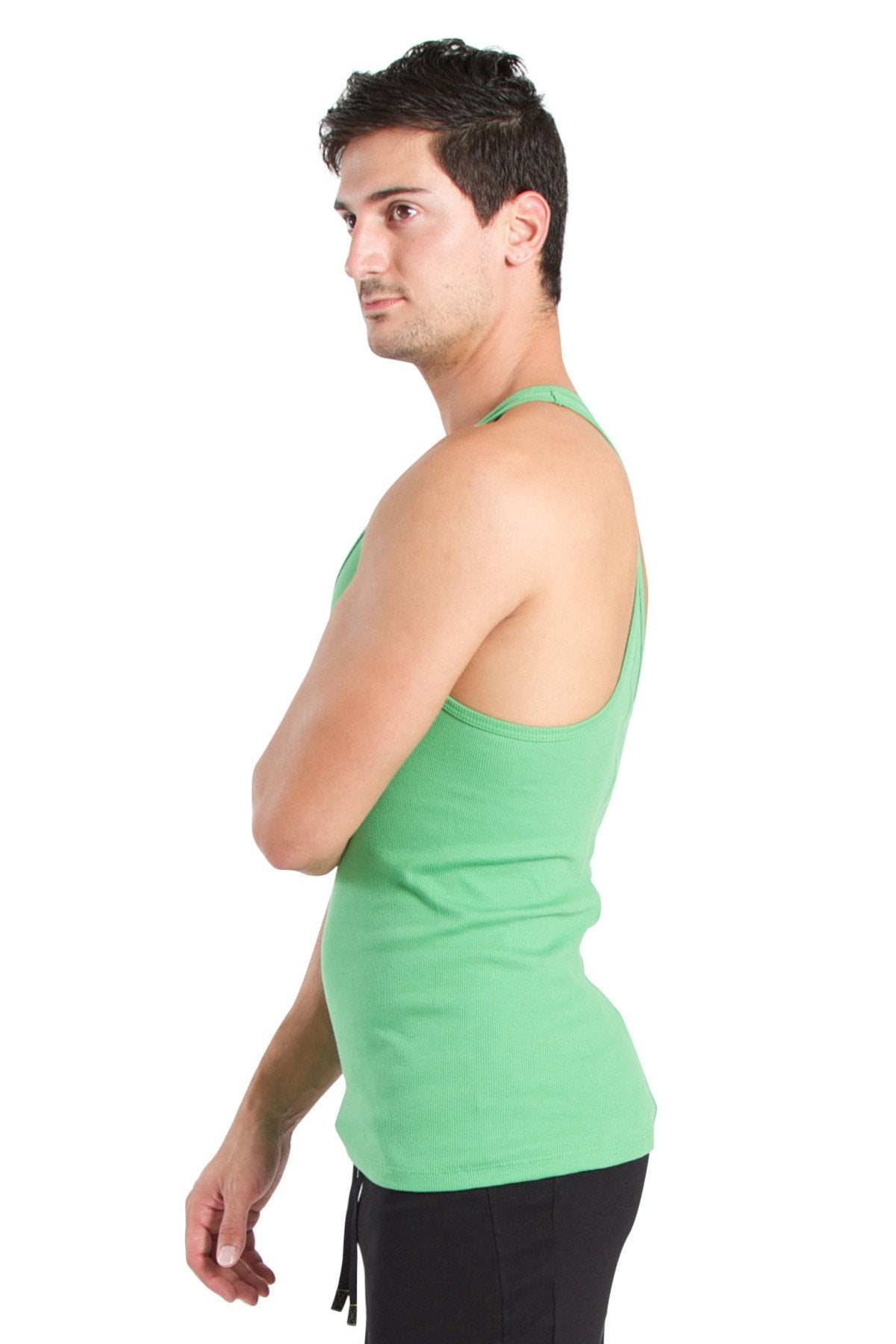 A man wearing a fitted solid green racerback yoga tank top made from bamboo fabric with thin straps