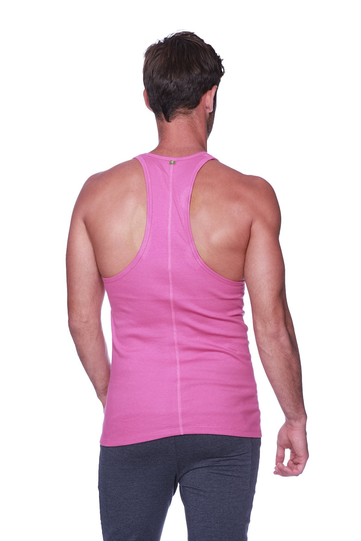 A vibrant pink form-fitting racerback yoga tank top with a subtle vertical seam down the center