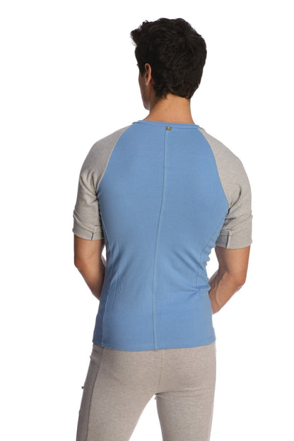 Back view of light blue and gray raglan virtual crew neck shirt with subtle vertical seam for athletic wear