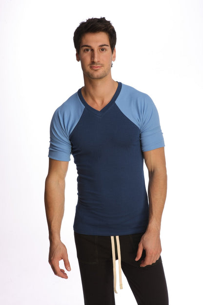 Navy blue and light blue raglan sleeve v neck t-shirt with subtle ribbed texture called raglan virtual crew neck royal blue