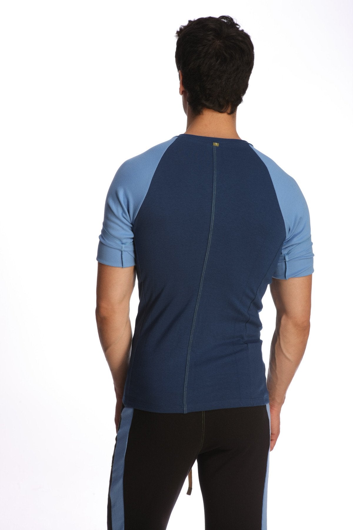 Back view of royal blue and light blue raglan virtual crew neck athletic shirt with central zipper down the back