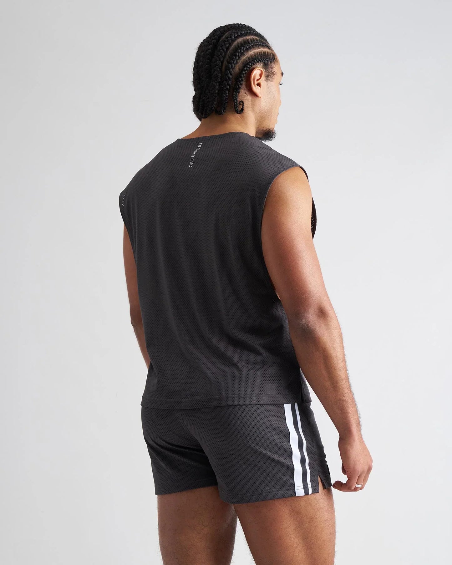 Black sleeveless s.s.c. mesh muscle tank with textured mesh fabric and subtle branding on the back side