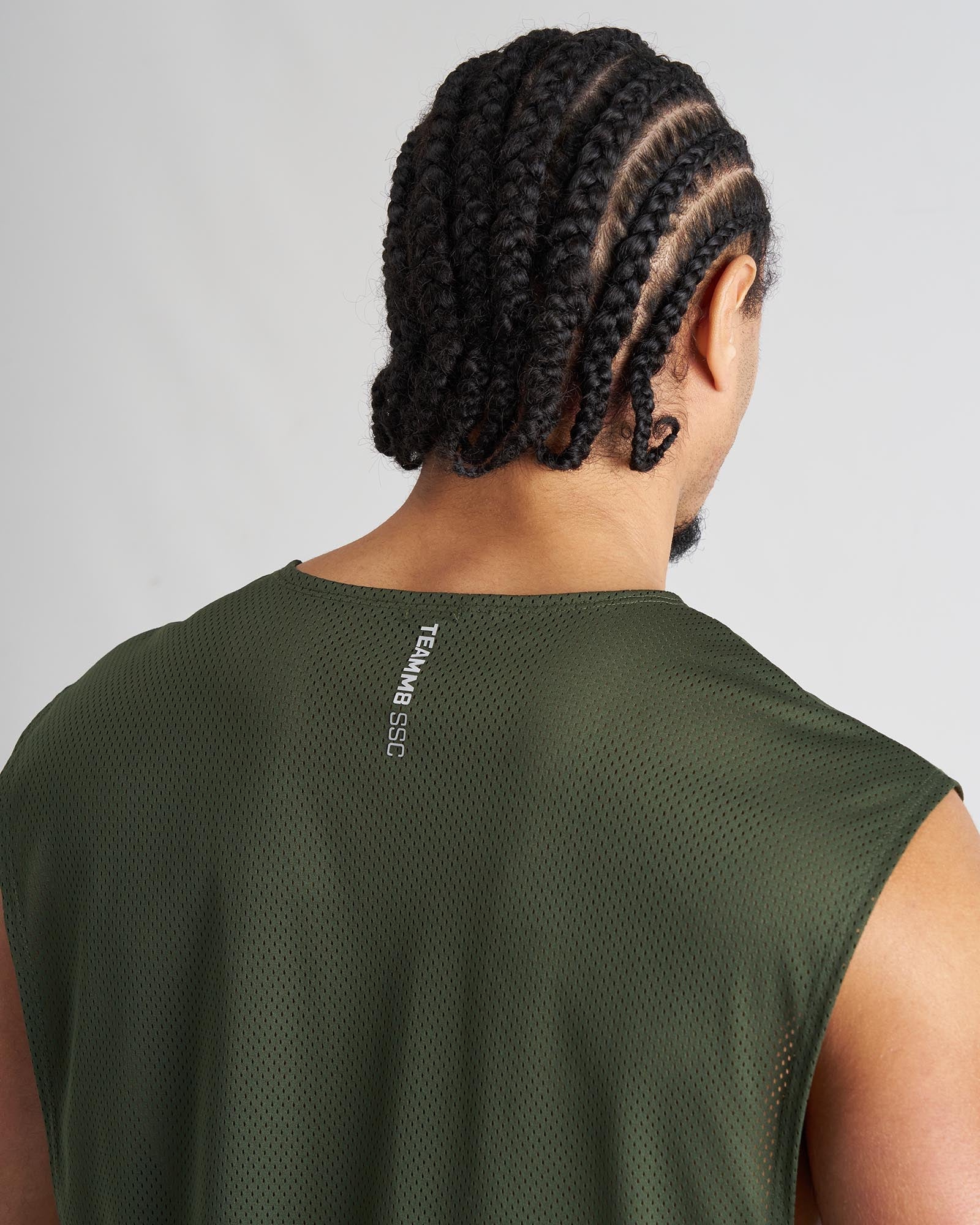 Back side of olive green mesh sleeveless athletic tank top with teammb ssg branding on the neckband for sports use