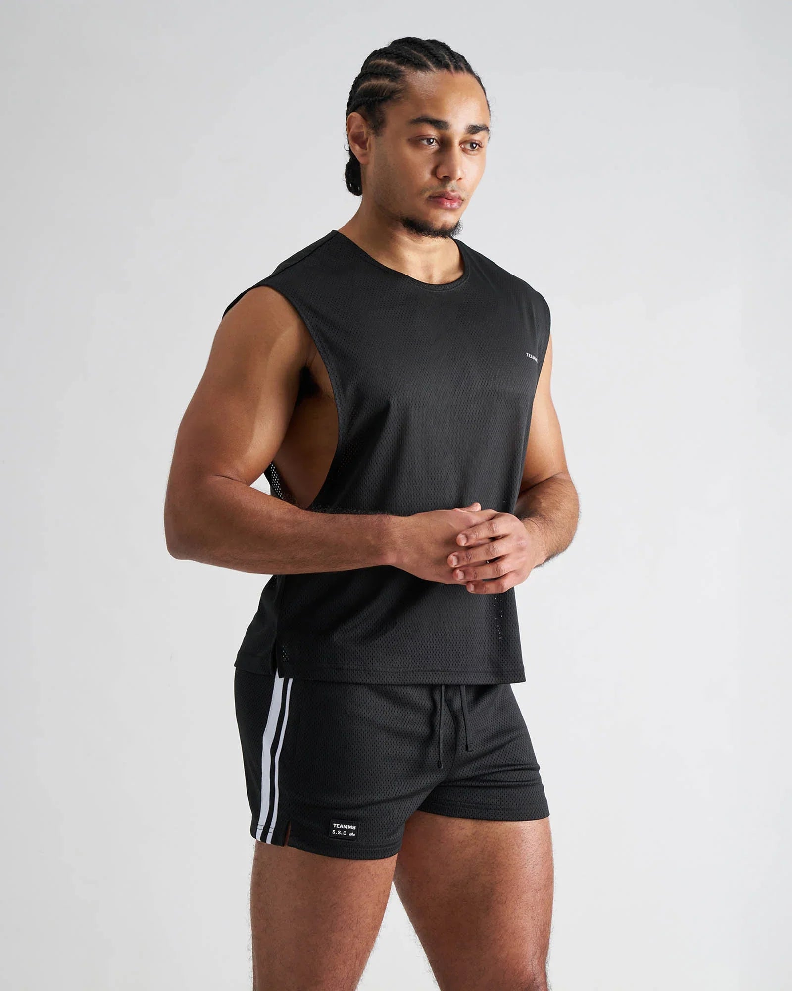 Black sleeveless athletic muscle tank with textured mesh fabric and subtle side vents for breathable performance