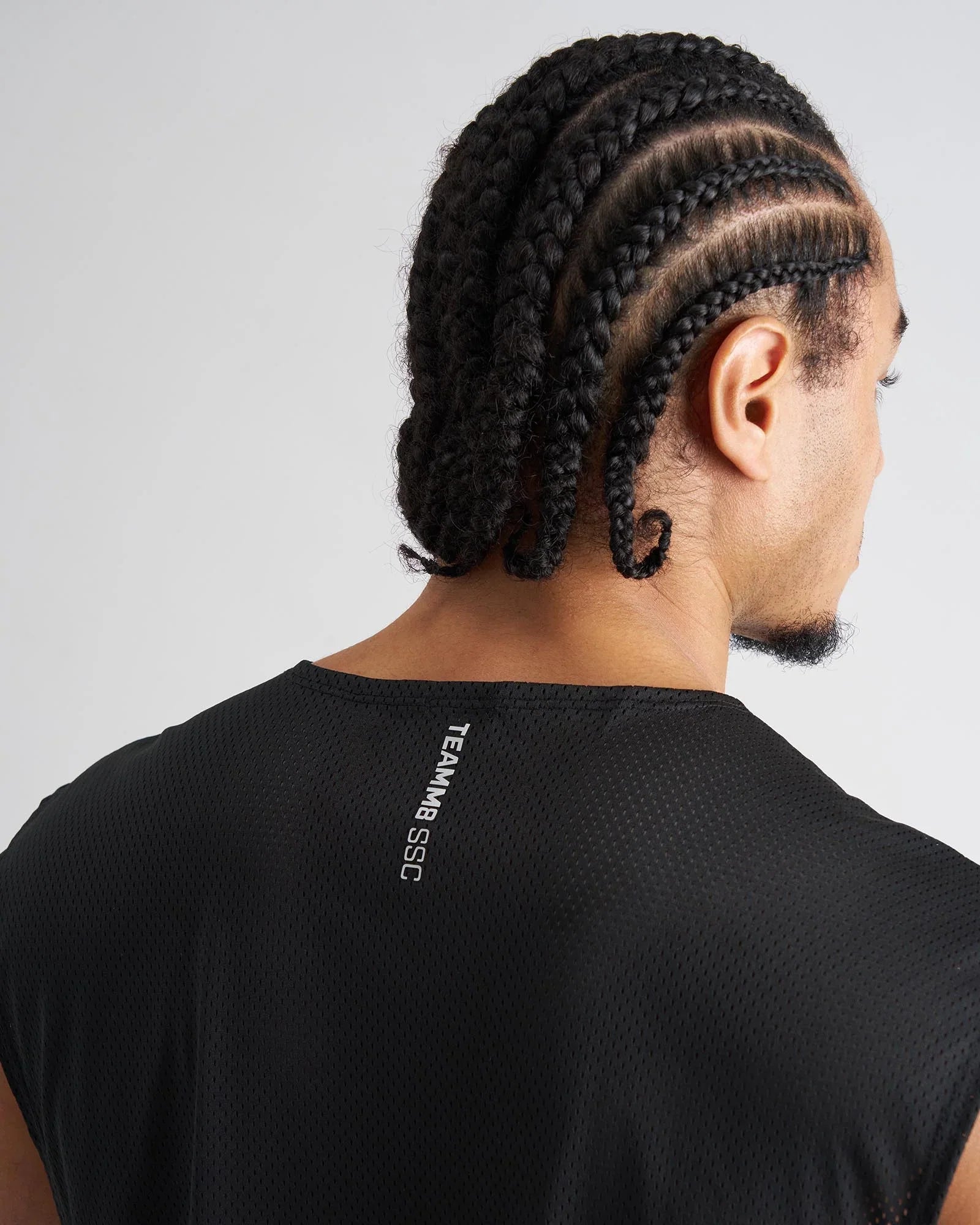 Black mesh sleeveless athletic muscle tank with teammb ssc branding on the back for sports and training