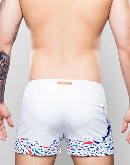 White s50 seascape print swim shorts with colorful fish pattern on hem and side and blue dolphin on right leg