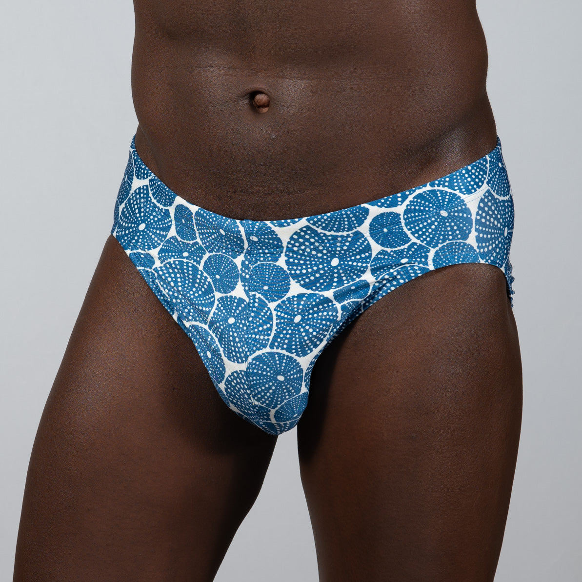Blue and white patterned swim trunks with circular dotted motifs from the sand dollar brief collection