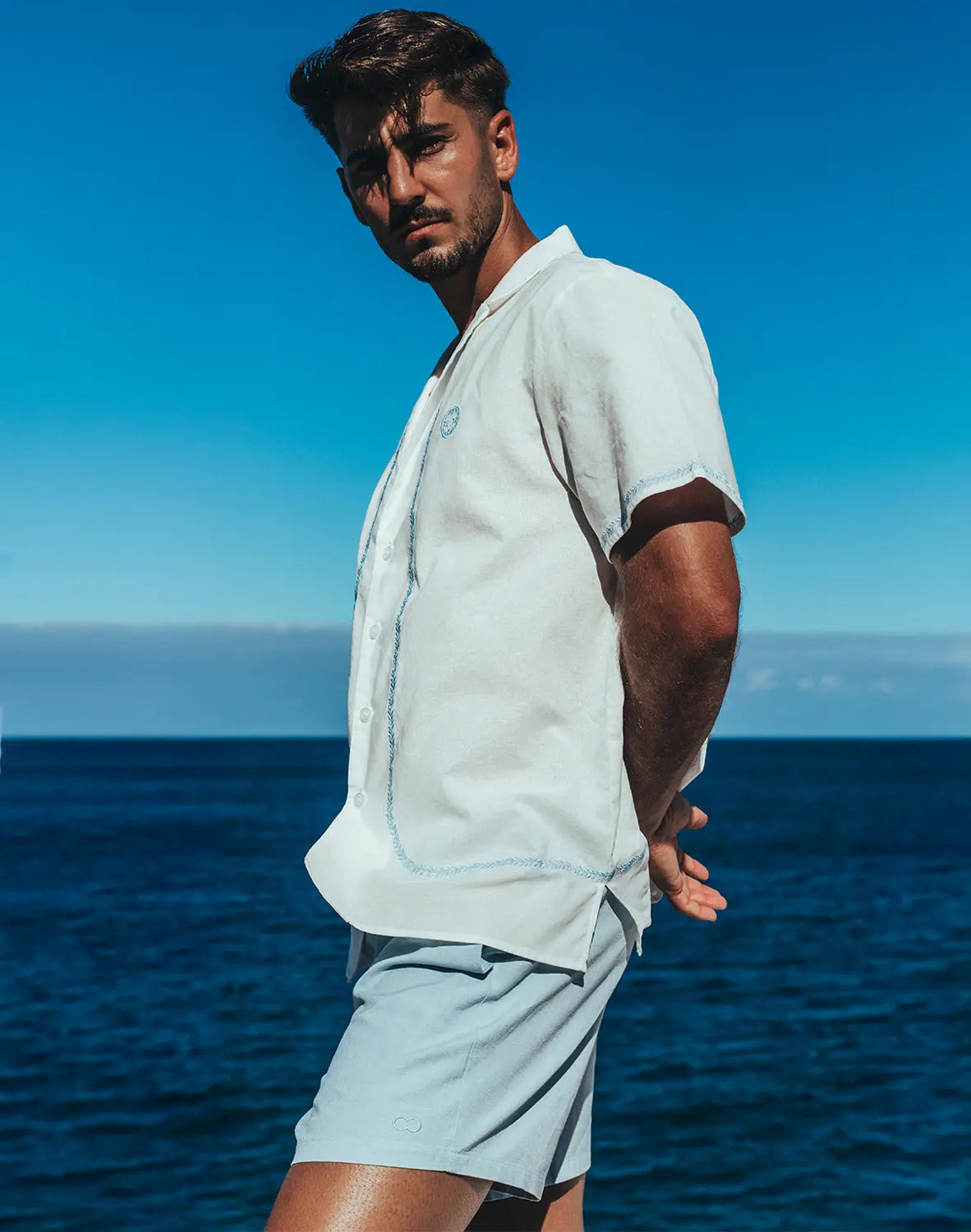 Light blue santorini linen shirt with short sleeves button up and subtle stitching details for casual wear