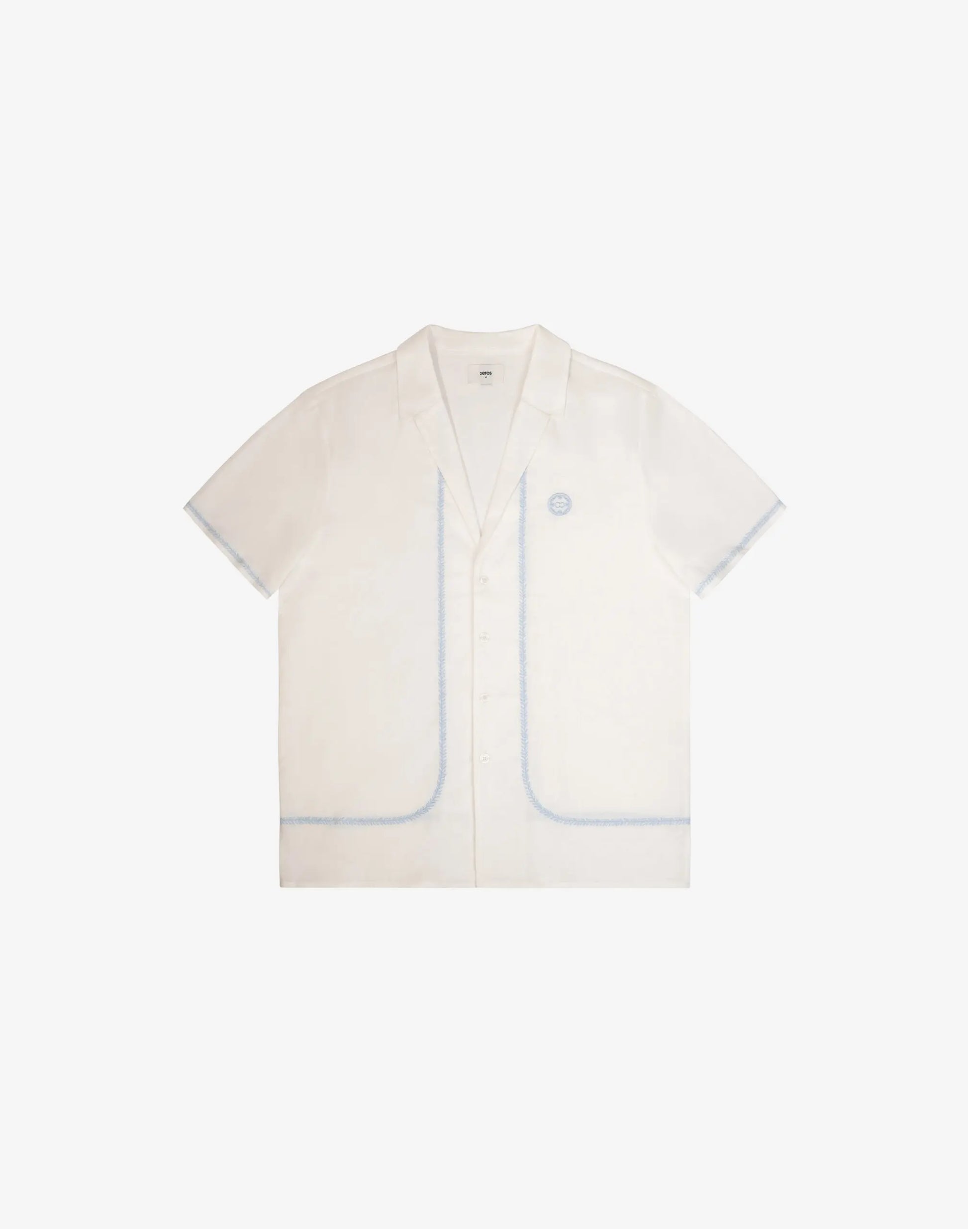 Santorini linen shirt is a crisp white short-sleeved button-up with subtle light blue piping on pockets and seams