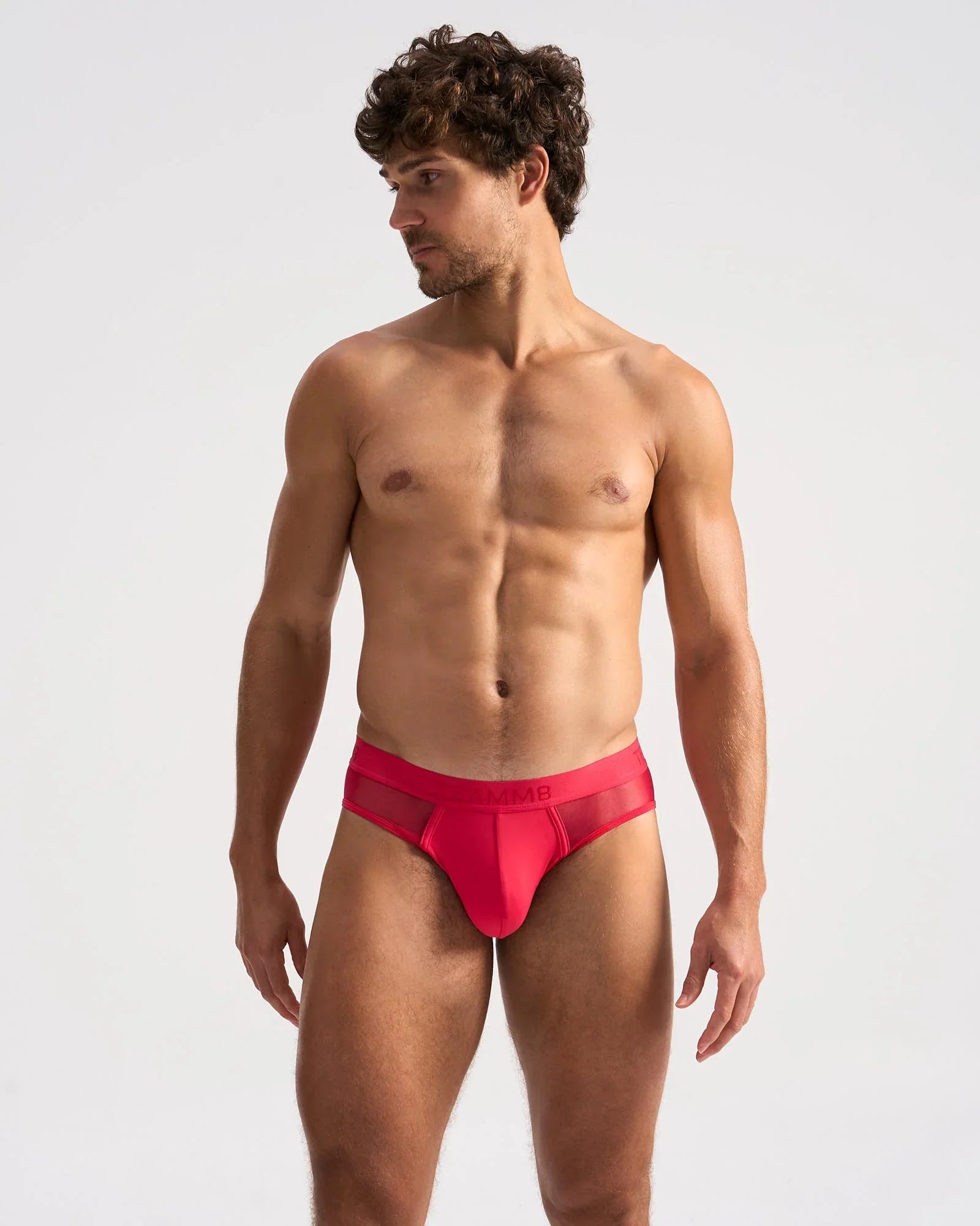 Bright red score sheer brief form-fitting briefs with a sheer mesh panel at the back visible in the image
