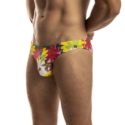 Vibrant floral-patterned second skin swimsuit men’s swim trunks in bold red yellow and green hues with playful design