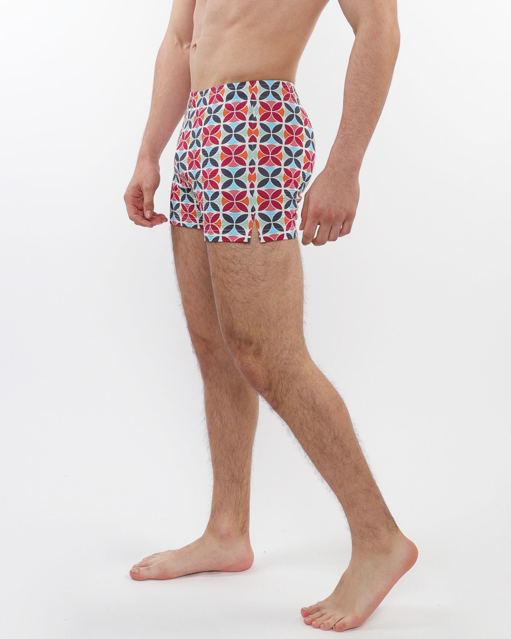Seersucker swim shorts with mesh lining featuring colorful red blue and white geometric patterns