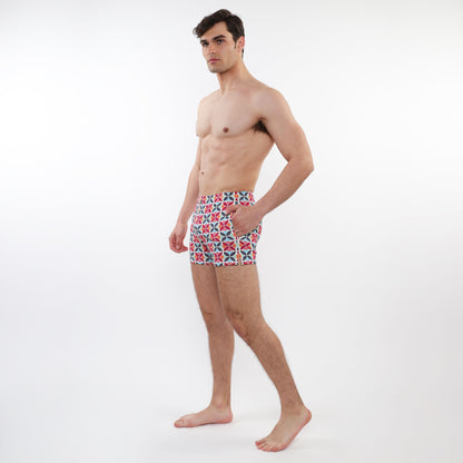 Men’s red white and navy blue geometric patterned briefs shown with seersucker swim shorts with mesh lining