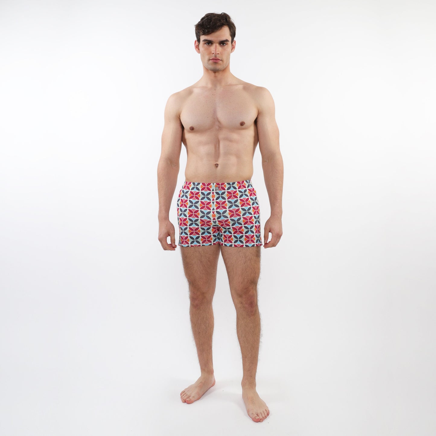 Men’s seersucker swim shorts with mesh lining featuring a vibrant red blue and white geometric pattern