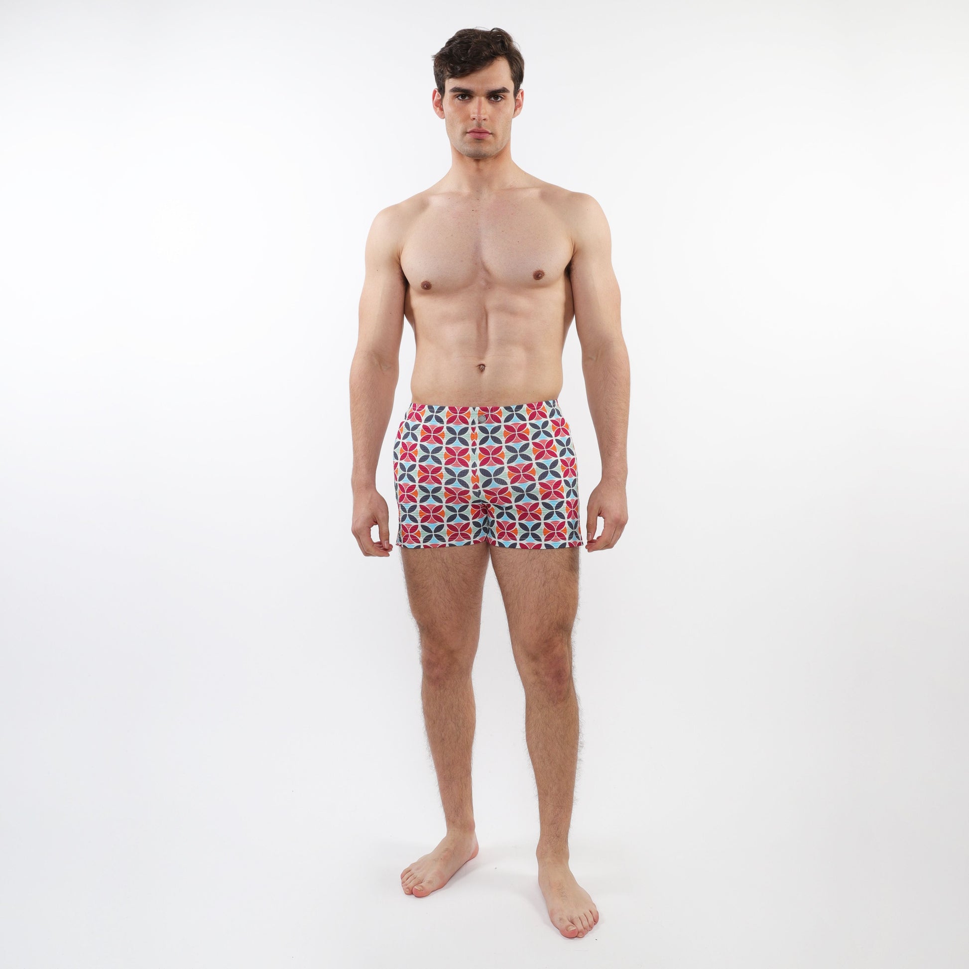 Men’s seersucker swim shorts with mesh lining featuring a vibrant red blue and white geometric pattern