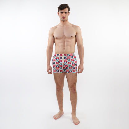Men’s seersucker swim shorts with mesh lining featuring a vibrant red blue and white geometric pattern