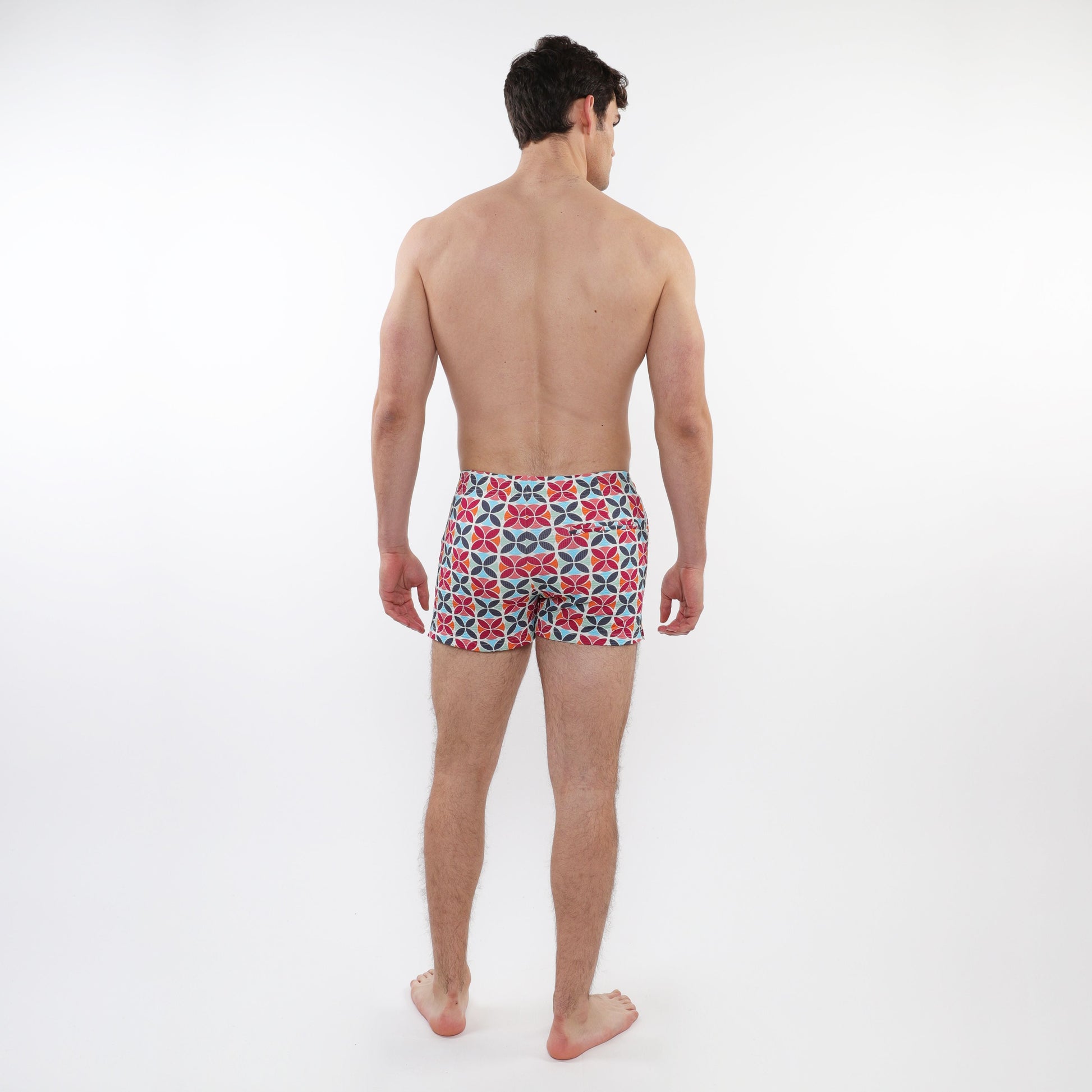 Men’s seersucker swim shorts with mesh lining featuring a bold red navy blue and white geometric pattern