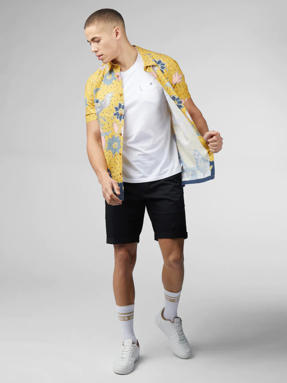 Yellow floral short-sleeved shirt with blue and pink accents featuring signature abstract botanical print design