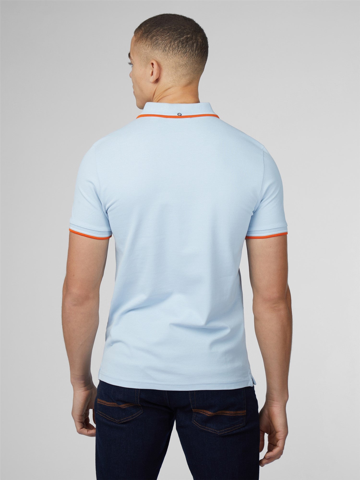 Light blue signature polo shirt with orange trim on collar and sleeve cuffs in breathable cotton fabric