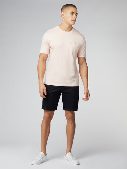 A pale pink short-sleeved crew neck signature t-shirt with a small embroidered chest pocket logo