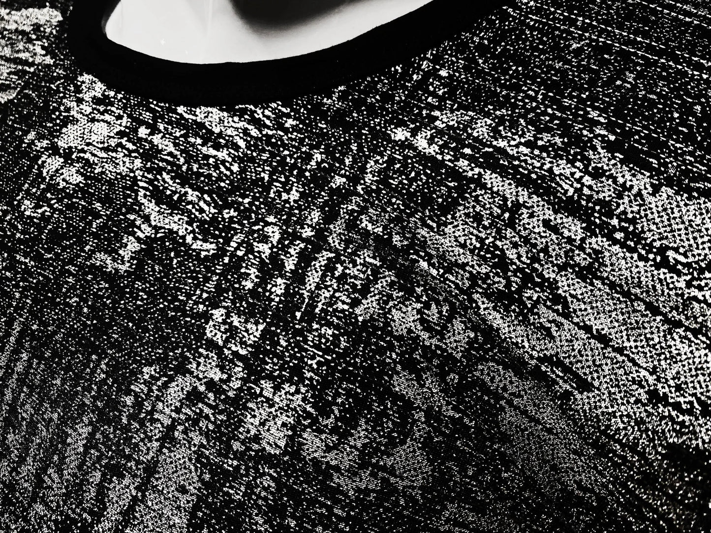 Black lace silver leaf tee with intricate textured pattern showcasing detailed craftsmanship