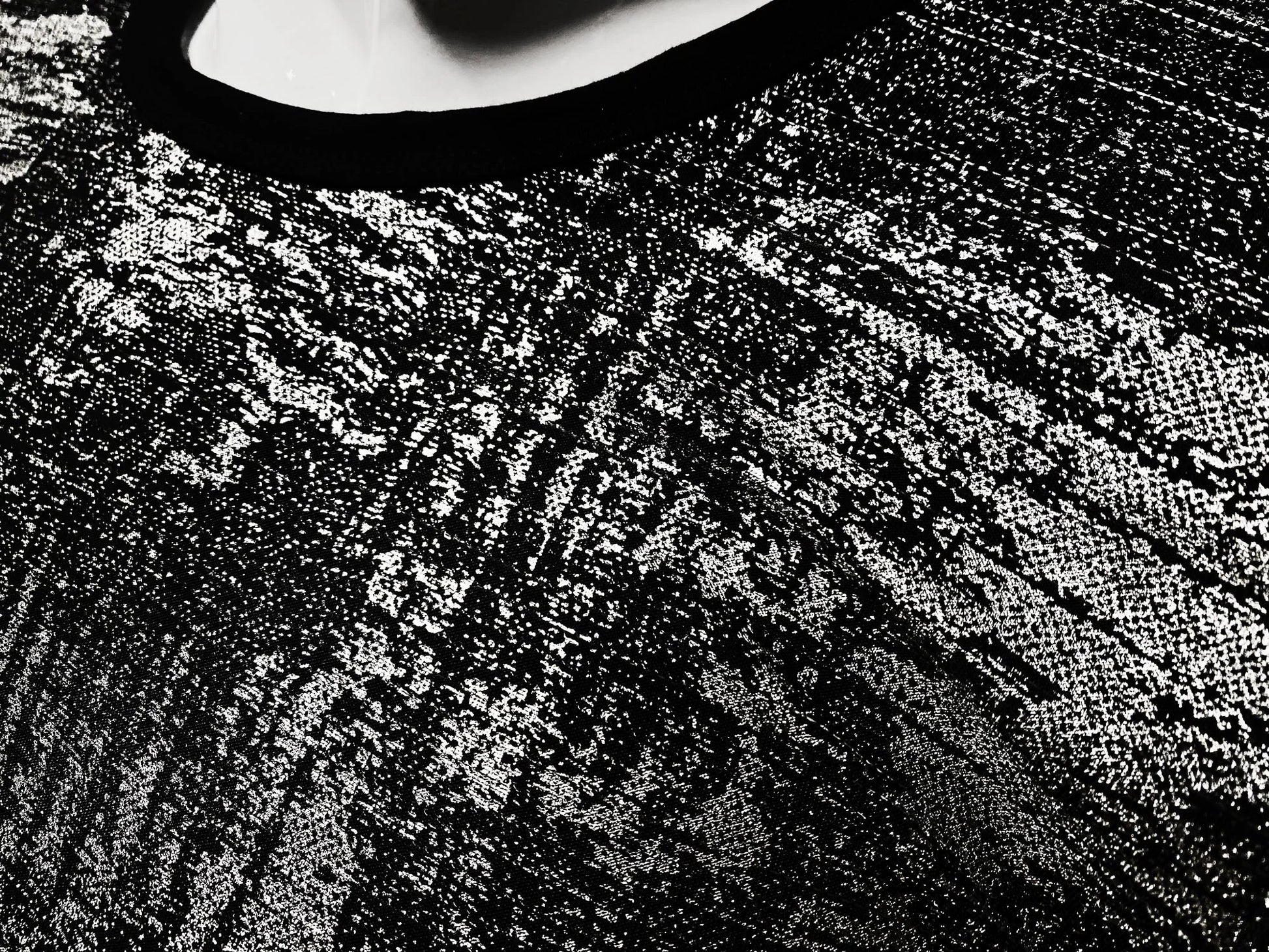Black lace silver leaf tee with intricate textured pattern showcasing detailed craftsmanship
