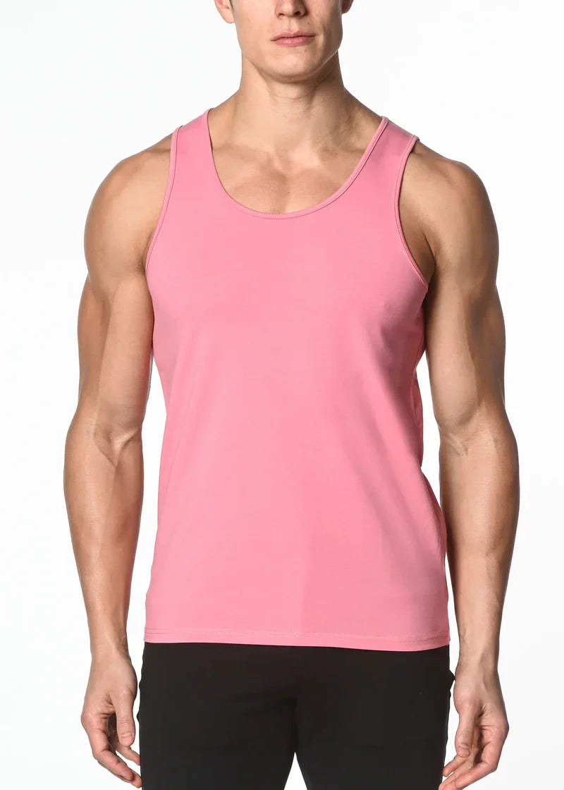 A sleek solid pink sleeveless solid stretch jersey tank top with rounded neckline and smooth fabric