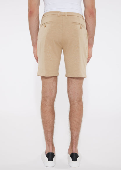 Beige solid stretch knit chino shorts with tailored fit and buttoned back pockets shown from the back side