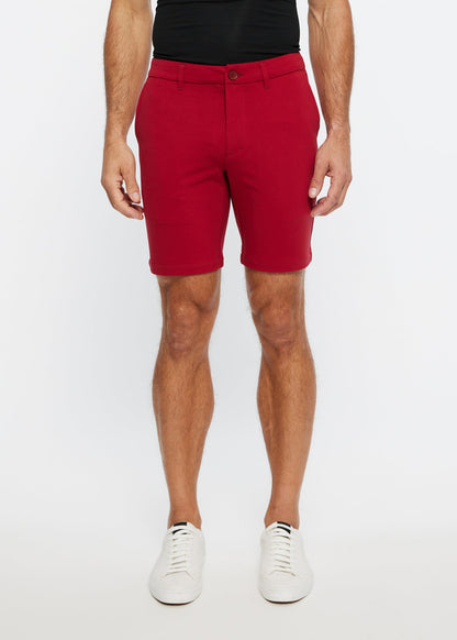 Red men’s solid stretch knit chino shorts with tailored fit and button closure for casual wear