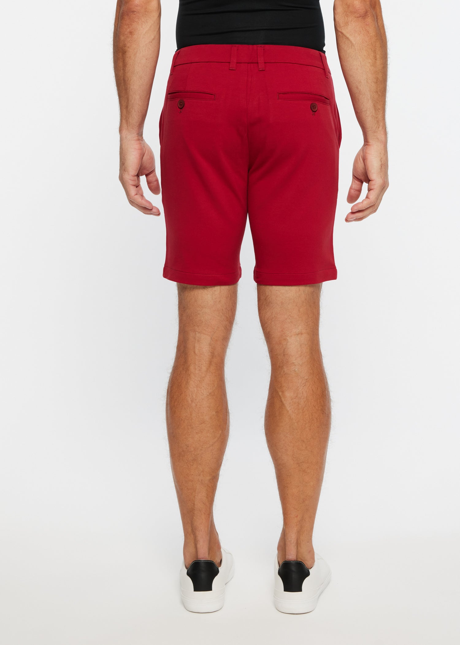 Red men’s solid stretch knit chino shorts with tailored fit and buttoned back pockets shown from the back side