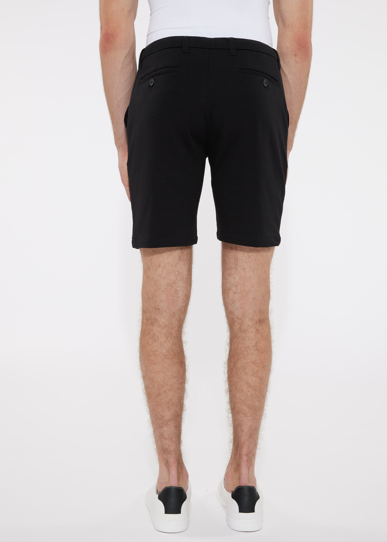 Black solid stretch knit shorts with a sleek modern cut and subtle side pockets designed for comfort and style