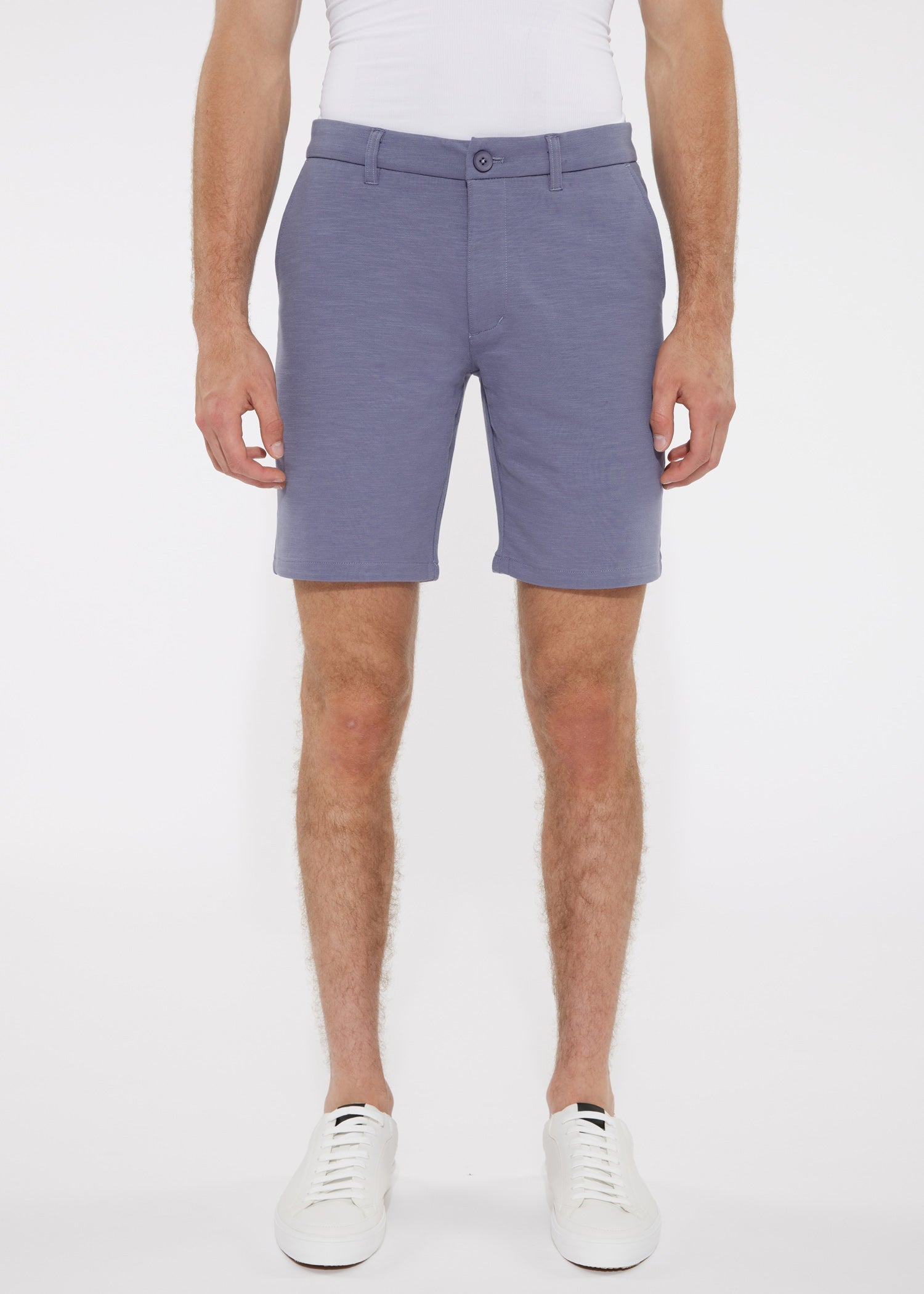 A pair of solid light blue men’s tailored shorts with stretch knit fabric belt loops and single button closure