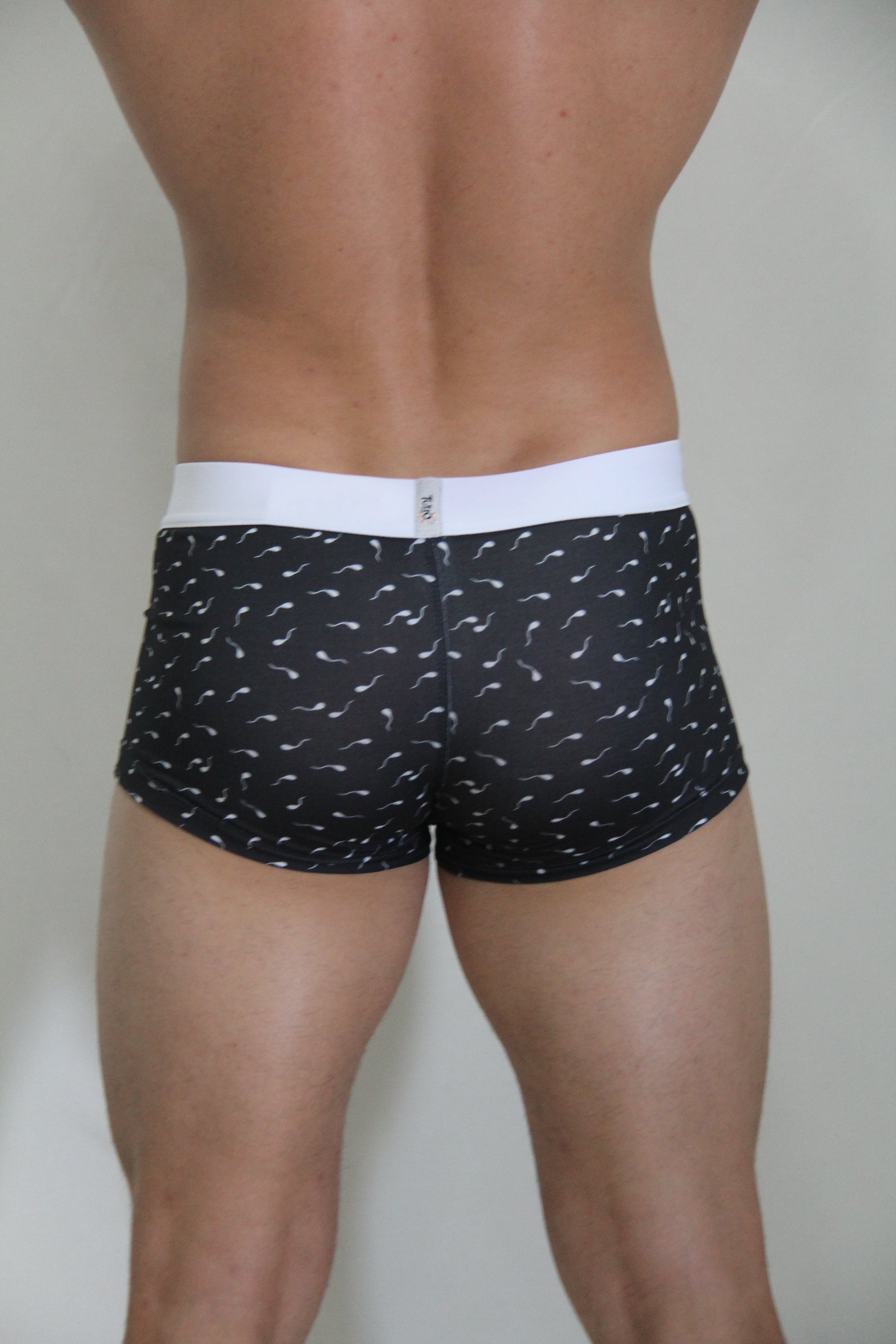 Black boxer briefs sperm trunk with white waistband and white stylized sperm pattern for casual wear